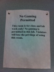 a sign that reads "no games or cell phones" in a computer lab where the presenters were planning to demo a twitter game.